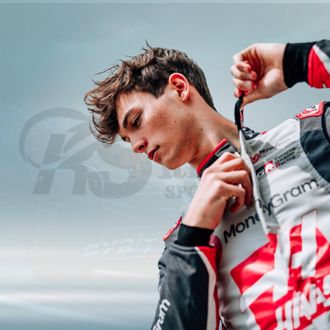 Person wearing a racing suit with visible branding against a blurred background