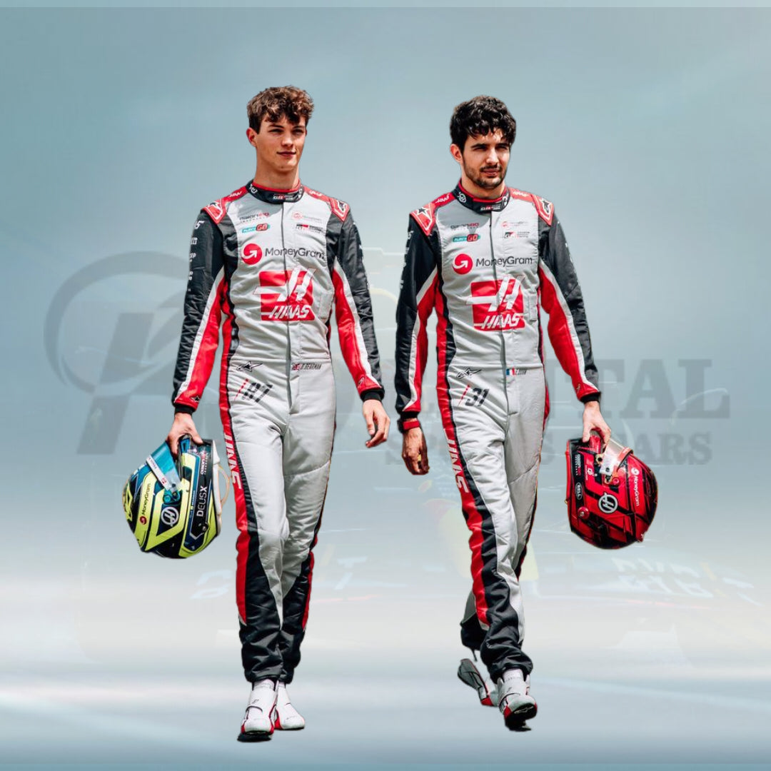 Two race car drivers in matching uniforms holding helmets against a light blue background.
