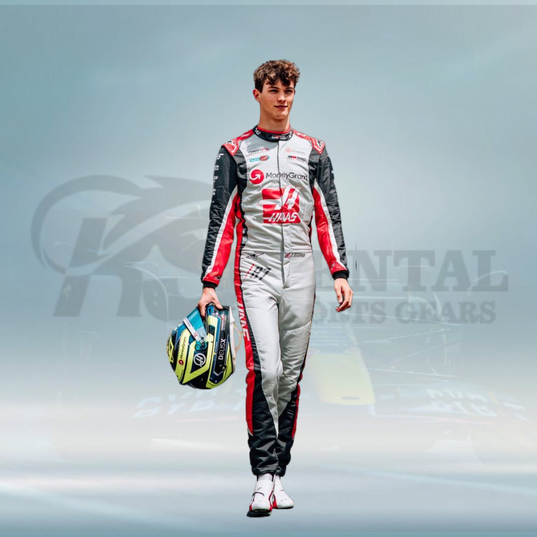 Person in a racing suit holding a helmet against a branded background